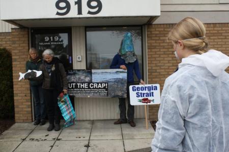 Alexandra in front of Mainstream Canada dropping mud on sidewalk 